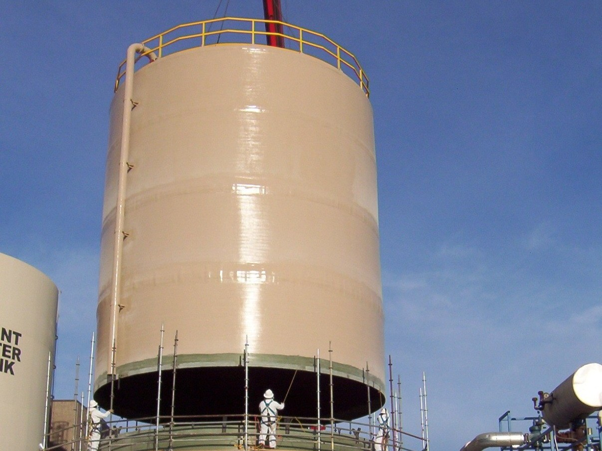 Upper shell course of a field-erected FRP tank being lowered onto the completed lower courses